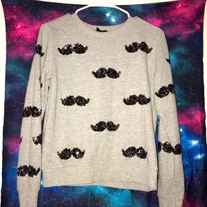 Gray sweater with sequined mustaches.